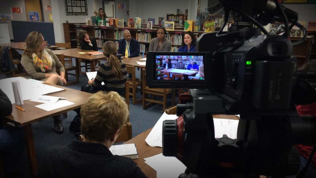 Video production taking place at a school board meeting